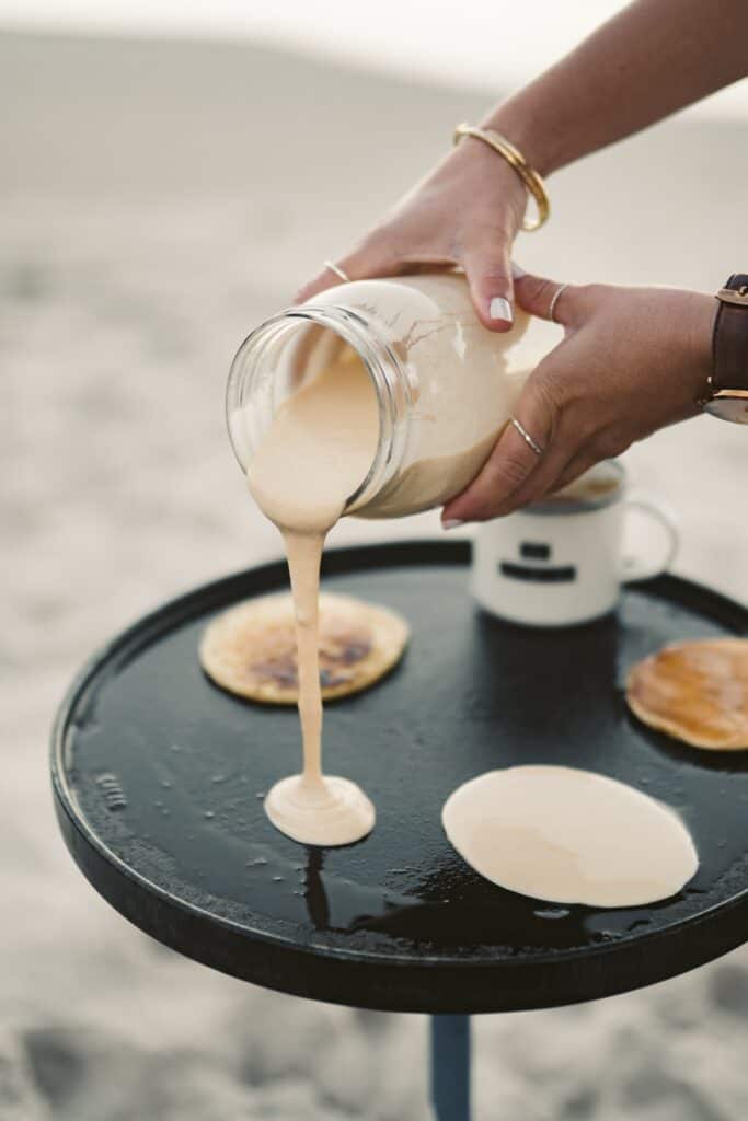 pouring pancake batter on the pan