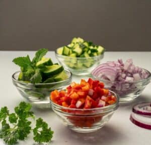diced-vegetables-such-as-cucumber-onion-bell-pepper-in-separate-small-glass-bowls