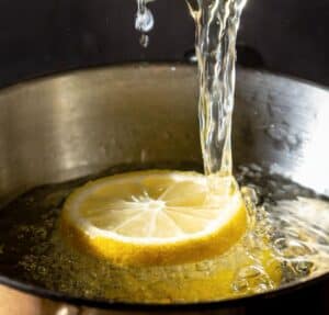 lemon-juice-and-vannila-extract-being-stirred-in-a-pan-under-low-heat