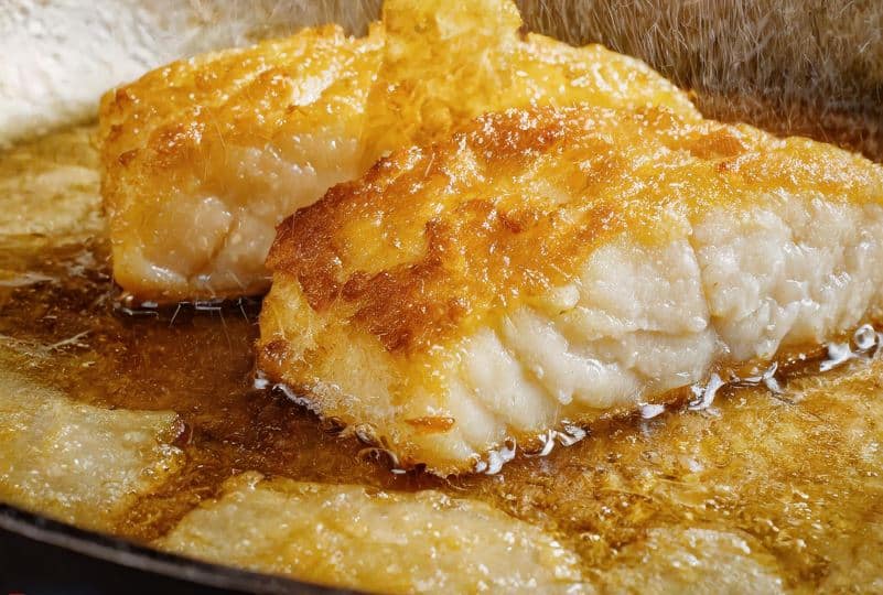 cod-fillets-being-fried-till-golden-brown-in-a-large-skillet