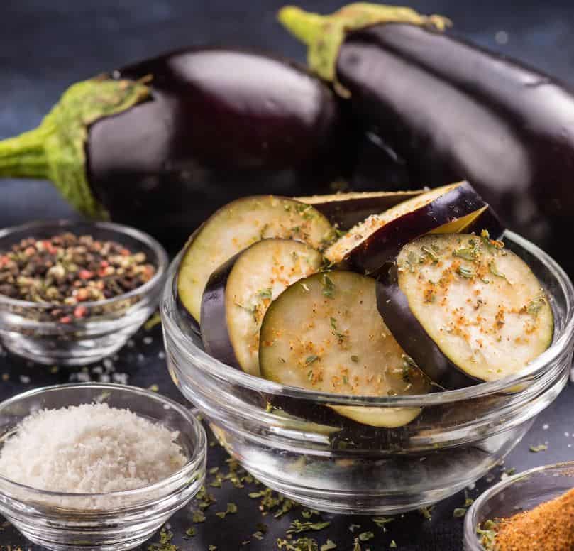 sliced-eggplants-in-bowl-along-with-grilled-eggplant-ingredients-in-small-bowls